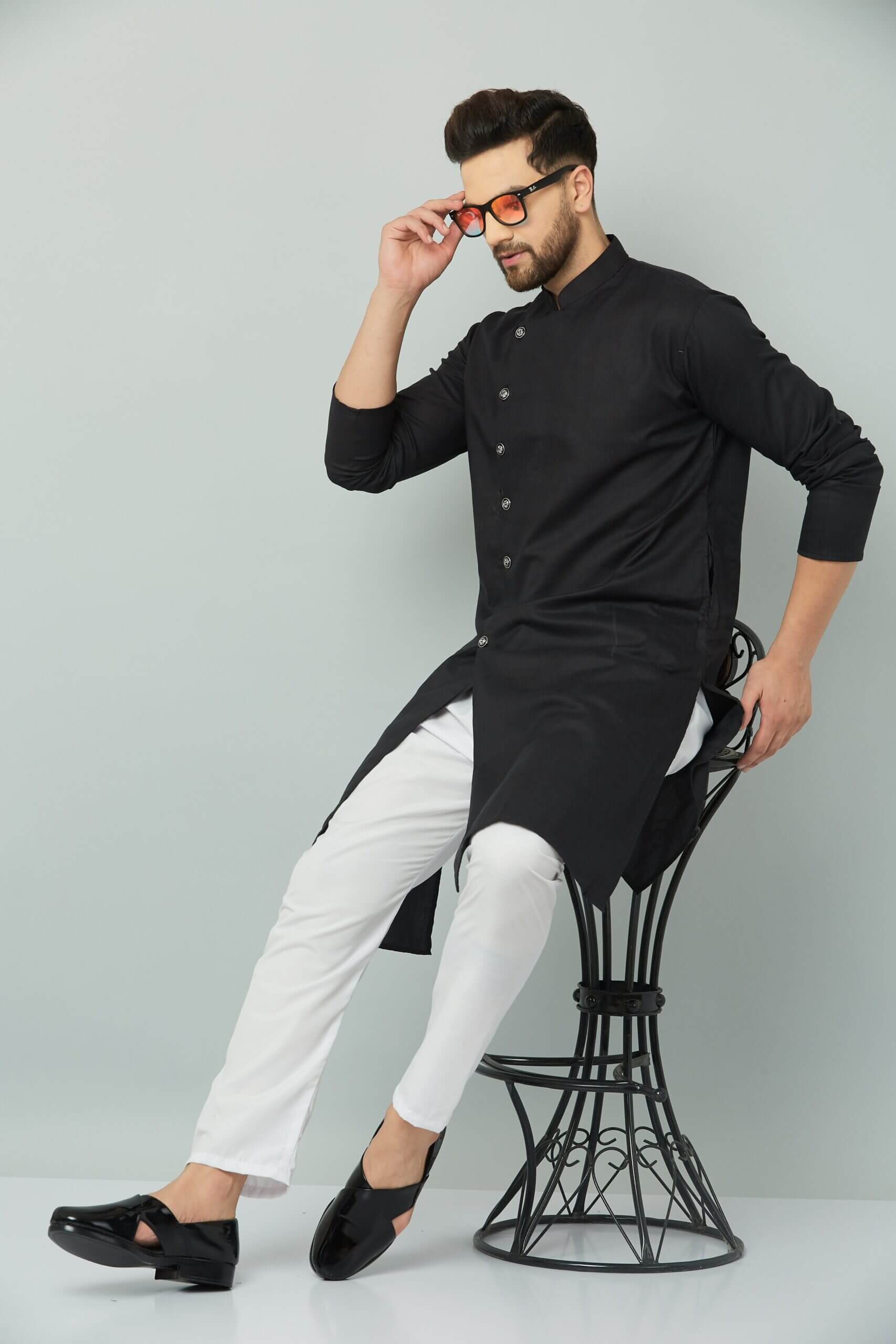 Cotton Royal Sherwani Type Kurta Set An individual wearing a black kurta and white pants seated on a chair. Indian kurta Teradozz brand