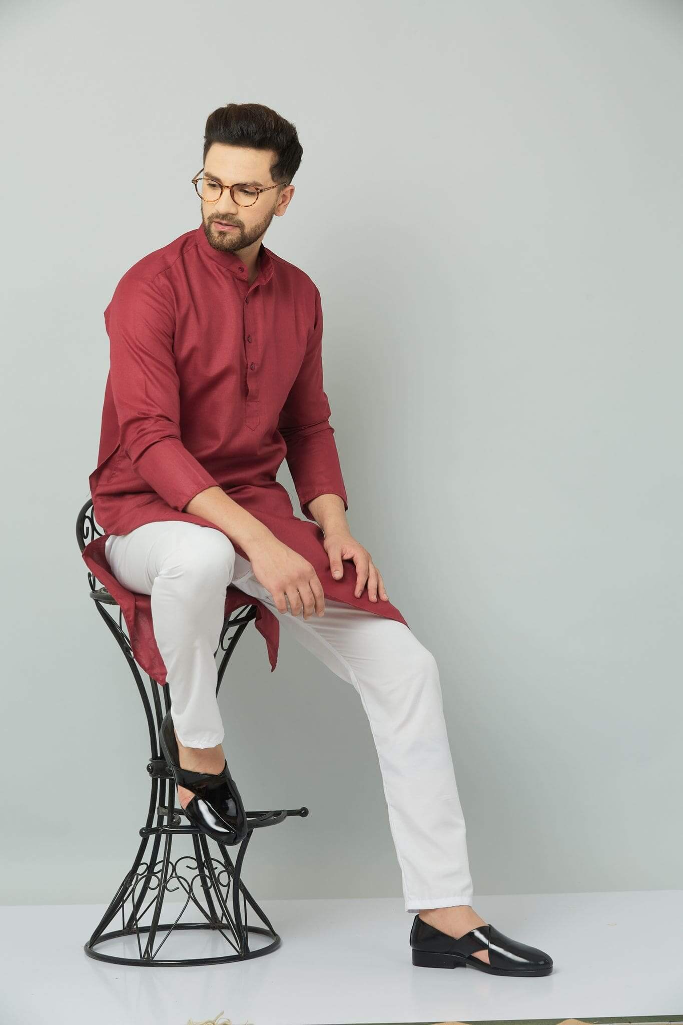 p (3)-min Man in maroon kurta sitting on stool.