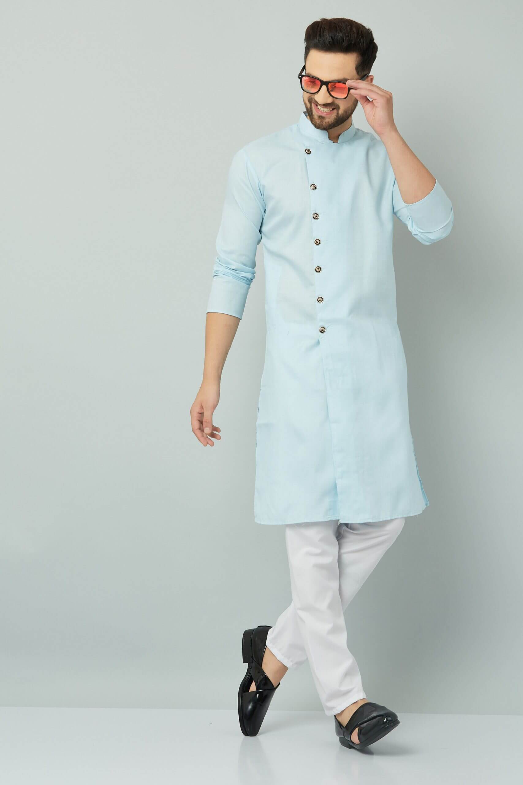 p (9)-min Traditional Indian men's blue kurta paired with white pants and black shoes.